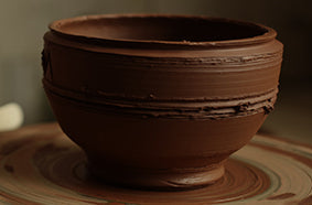 A clay bowl that is ready for firing